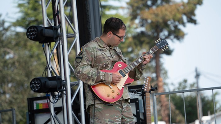 US Army Rock Band member playing electric guitar